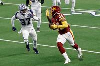 Washington Football Team running back Antonio Gibson (24) gestures with his hand as he gets past Dallas Cowboys safety Donovan Wilson (37) on his way to the end zone for a touchdown in the second half of an NFL football game in Arlington, Texas, Thursday, Nov. 26, 2020.