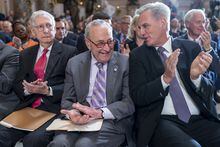 From left, Senate Minority Leader Mitch McConnell, R-Ky., Senate Majority Leader Chuck Schumer, D-N.Y., and Speaker of the House Kevin McCarthy, R-Calif., take time out from their struggle over the debt limit negotiations as they applaud during a portrait-unveiling ceremony for former Speaker of the House Paul Ryan, R-Wis., at the Capitol in Washington, Wednesday, May 17, 2023. (AP Photo/J. Scott Applewhite)