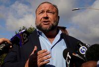Alex Jones speaks to reporters at the court house as he faces a second defamation trial over Sandy Hook claims in Waterbury, Connecticut, U.S., September 20, 2022.   REUTERS/Michelle McLoughlin