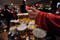 Hockey fans load up on beer at a bar in Edmonton on Dec. 31, 2011. The southern Alberta town of Raymond -- dry since it was founded more than 100 years ago -- is asking residents if they are for or against restaurants serving alcohol. THE CANADIAN PRESS/Nathan Denette