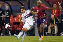 Vancouver Whitecaps forward Simon Becher (29) kicks the ball against FC Dallas defender Nkosi Tafari (17) during the second half of an MLS soccer match Wednesday, May 17, 2023, in Frisco, Texas. (AP Photo/LM Otero)