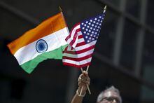 FILE PHOTO: A man holds the flags of India and the U.S. in New York August 16, 2015. REUTERS/Eduardo Munoz/File Photo