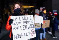 Demonstrators stand outside the courthouse on the first day of the constitutional challenge to Bill 21 before the Quebec Superior Court, in Montreal on Nov. 2, 2020.