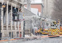 Investigators survey the scene following a fire in Old Montreal, Sunday, March 19, 2023, that gutted a heritage building. Police say the search continues for the six people missing after a fire swept through a historic Old Montreal building last week. THE CANADIAN PRESS/Graham Hughes