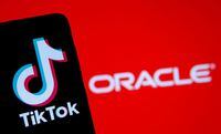 FILE PHOTO: A smartphone with the Tik Tok logo is seen in front of a displayed Oracle logo in this illustration taken, Septemeber 14, 2020. REUTERS/Dado Ruvic/Illustration