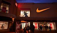 (FILES) In this file photo taken on May 21, 2019 shows shoppers at an outlet mall exit a Nike store in Los Angeles. - Nike shares rocketed higher September 22, 2020, after the company reported blowout quarterly earnings on strong digital sales and its CEO cheered the return of pro sports. (Photo by Frederic J. BROWN / AFP) (Photo by FREDERIC J. BROWN/AFP via Getty Images)