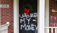 Graffiti reading, "Where's my money" is seen on a door of the home of Senate Majority Leader Mitch McConnell, R-Ky., in Louisville, Ky., on Saturday, Jan. 2, 2021. As of Saturday morning, messages like wheres my money and other expletives were written with spray paint across the front door and bricks of the Kentucky Republicans Highlands residence.    (AP Photo/Timothy D. Easley)