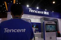 FILE PHOTO: A staff member is seen at a booth of Tencent at an exhibition during China Internet Conference in Beijing, China July 13, 2021. REUTERS/Tingshu Wang/File Photo
