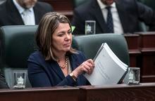 Alberta Premier Danielle Smith listens as Alberta Finance Minister Travis Toews delivers the 2023 budget, in Edmonton on Tuesday, February 28, 2023. THE CANADIAN PRESS/Jason Franson 