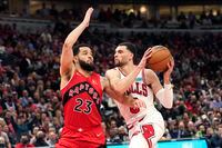 Chicago Bulls' Zach LaVine, right, drives two the basket as Toronto Raptors' Fred VanVleet defends during the second half of an NBA basketball game Monday, March 21, 2022, in Chicago. The Bulls won 113-99. (AP Photo/Charles Rex Arbogast)