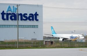 Transat AT Inc. reported a second-quarter loss of $29.2 million compared with a loss of $98.3 million last year as its revenue more than doubled. An Air Transat plane is seen as an Air Canada plane lands at Pierre Elliott Trudeau International Airport in Montreal on Thursday, May 16, 2019. THE CANADIAN PRESS/Ryan Remiorz