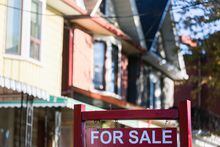 A for sale sign is displayed in front of a house in the Riverdale area of Toronto on Wednesday, September 29, 2021. As the country's real estate market cools, the Canadian Real Estate Association is expected to release home sales figures for July. THE CANADIAN PRESS/Evan Buhler