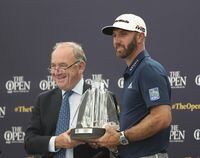 FILE - Dustin Johnson, right, receives The Mark H McCormack award for being the leading playing in the Official World Golf rankings for 2018, from OWGR Chairman Peter Dawson during a ceremony ahead of the British Open golf championships at Royal Portrush in Northern Ireland, Tuesday, July 16, 2019. Dawson says the OWGR has denied the application for LIV Golf to receive ranking points. (AP Photo/Jon Super, File)