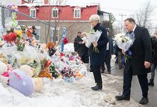 Quebec Premier Francois Legault and wife Isabelle Brais bring flowers to the site of a daycare centre in Laval, Que, Thursday, February 9, 2023, where a bus crashed into the building killing two children. THE CANADIAN PRESS/Graham Hughes 
