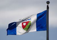 The Northwest Territories provincial flag flies on a flag pole in Ottawa on June 30, 2020. Five homes have been lost to a wildfire in a community in the Northwest Territories in the last two days, as the fire remains out of control about 100 kilometres northwest of Yellowknife. THE CANADIAN PRESS/Adrian Wyld