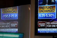 A monitor displays information about the Federal Reserve interest rate on the floor at the New York Stock Exchange in New York, Wednesday, Sept. 20.