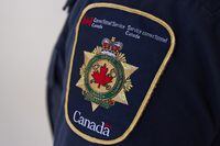A shoulder patch on a correctional officer is shown at the Collins Bay Institution in Kingston, Ont., on Tuesday, May 10, 2016. The Correctional Service of Canada said it is working to provide timely access to addiction treatment after settling a human rights complaint launched in 2018. THE CANADIAN/Lars Hagberg