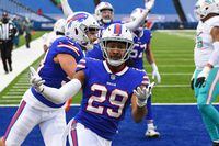 Jan 3, 2021; Orchard Park, New York, USA; Buffalo Bills cornerback Josh Norman (29) gestures after his interception return for a touchdown against the Miami Dolphins during the third quarter at Bills Stadium. Mandatory Credit: Rich Barnes-USA TODAY Sports