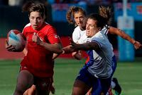 Canada's Ghislaine Landry, left, runs past France players during the Women's Rugby Sevens World Cup in San Francisco, Friday, July 20, 2018. After a disappointing sixth-place finish in the season opener in Glendale, Colo., the Canadian women's rugby sevens team hopes to get back on track in Dubai on the HSBC World Rugby Sevens Series. THE CANADIAN PRESS/AP Photo-Jeff Chiu