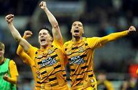 Cambridge United's George Williams, left, and Harvey Knibbs celebrate victory after the final whistle of the English FA Cup third round soccer match between Newcastle United and Cambridge United at St. James' Park, Newcastle upon Tyne, England, Saturday Jan. 8, 2022. (Owen Humphreys/PA via AP)