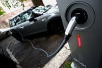 FILE PHOTO: An electric car is seen plugged in at a charging point for electric vehicles in Rome, Italy, April 28, 2021. REUTERS/Guglielmo Mangiapane/File Photo