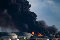 View of the massive fire at a fuel depot in Matanzas, Cuba, on August 7, 2022. - Planes with products, firefighters and specialists from Mexico and Venezuela arrived in Cuba to help put out this Sunday the fire of two oil tanks, which enters its third day with one dead, 17 missing and 36 hospitalized. (Photo by YAMIL LAGE / AFP) (Photo by YAMIL LAGE/AFP via Getty Images)