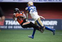 B.C. Lions' Dominique Rhymes, left, makes a reception as Winnipeg Blue Bombers' Winston Rose defends during the first half of CFL football game in Vancouver, on July 9, 2022. Any other year, Rhymes would be the B.C. Lions' finalist for the CFL's outstanding player award. But career highs in catches (82), receiving yards (1,346) and touchdowns (11) have come in the same campaign as Canadian quarterback Nathan Rourke took the league by storm before requiring surgery for a foot injury. THE CANADIAN PRESS/Darryl Dyck