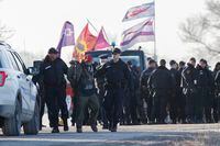 OPP officers take a man into custody as officers moved in to dismantle First Nations members of the Tyendinaga Mohawk Territory's camp next to a railway crossing, in support of the Wet'suwet'en Nation who are trying to stop the construction of British Columbia's Coastal GasLink pipeline, in Tyendinaga, Ontario, Canada, Tyendinaga Mohawk Territory on Monday, February 24, 2020. (Cole Burston/The Globe and Mail)