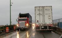 FILE PHOTO: Cross-border transport trucks cross paths on the Peace Bridge at the Canada U.S. border in Buffalo, New York, U.S., January 10, 2018.REUTERS/Hyungwon Kang/File Photo