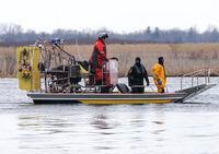Searchers look for victims Friday, March 31, 2023 after a boat capsized in Akwesasne, Que. Akwesasne Mohawk police say are suspending the organized search of local waterways for a man linked to the eight migrants whose bodies were pulled from the St. Lawrence River last week. THE CANADIAN PRESS/Ryan Remiorz