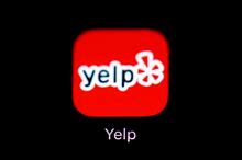 FILE- This March 19, 2018, file photo shows the Yelp app on an iPad in Baltimore. Yelp reports financial results Thursday, May 9, 2019. (AP Photo/Patrick Semansky, File)
