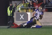 CORRECTS REDBLACKS PLAYER TO PATRICK LEVELS Winnipeg Blue Bombers wide receiver Dalton Schoen (#83) scores a touchdown behind the Ottawa Redblacks defensive back Patrick Levels during second half CFL action at TD Place Stadium in Ottawa on Friday June 17, 2022. THE CANADIAN PRESS/Lars Hagberg