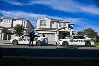 Security personals stand outside the rented house of the Former President of Brazil Jair Bolsonaro at the Encore Resort at Reunion in Kissimmee, Florida, Miami, on January 10, 2023. - Brazilian far-right ex-president Jair Bolsonaro has been hospitalized with abdominal pain, his wife said on January 9, 2023, a day after his supporters invaded the seat of power in Brasilia. Media reports said Bolsonaro had been admitted to AdventHealth Celebration acute care hospital outside Orlando, Florida, where the former president traveled two days before the end of his term on December 31. (Photo by CHANDAN KHANNA / AFP) (Photo by CHANDAN KHANNA/AFP via Getty Images)