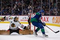 Chicago Blackhawks goalie Marc-Andre Fleury, left, stops Vancouver Canucks' Elias Pettersson, of Sweden, during second period NHL hockey action in Vancouver, B.C., Sunday, Nov. 21, 2021. THE CANADIAN PRESS/Darryl Dyck