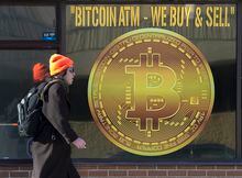 A sign advertises a Bitcoin automated teller machine, ATM, at a shop in Halifax on Wednesday, February 4, 2020. THE CANADIAN PRESS/Andrew Vaughan